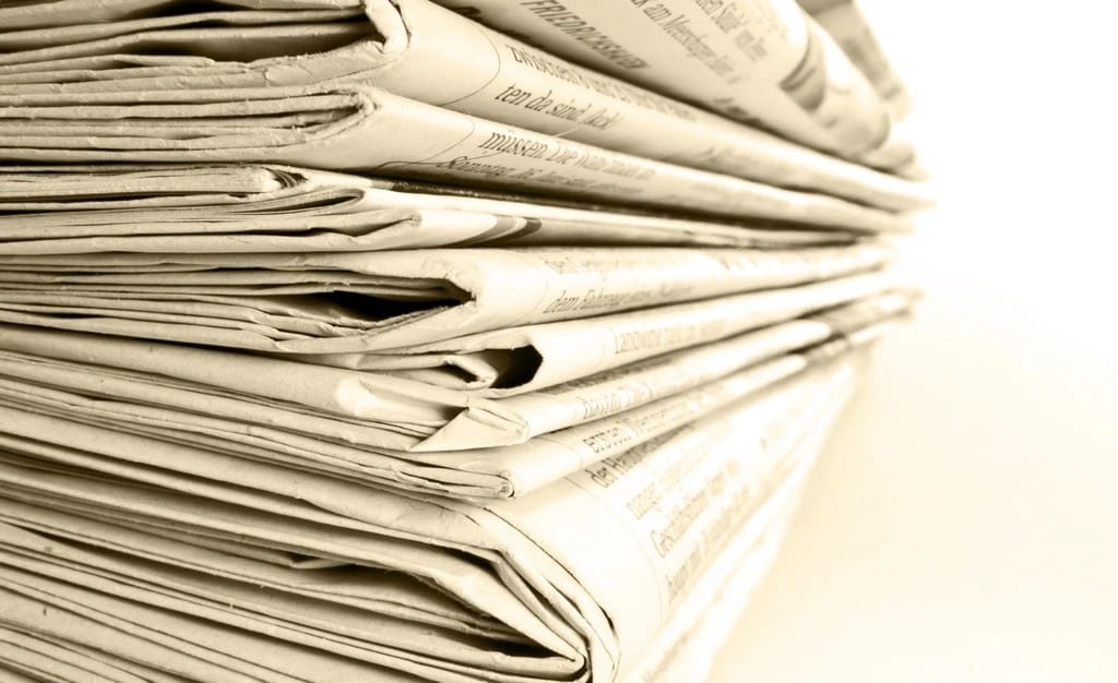 a stack of newspapers representing the earned media coverage digital PR for SEO aims to secure