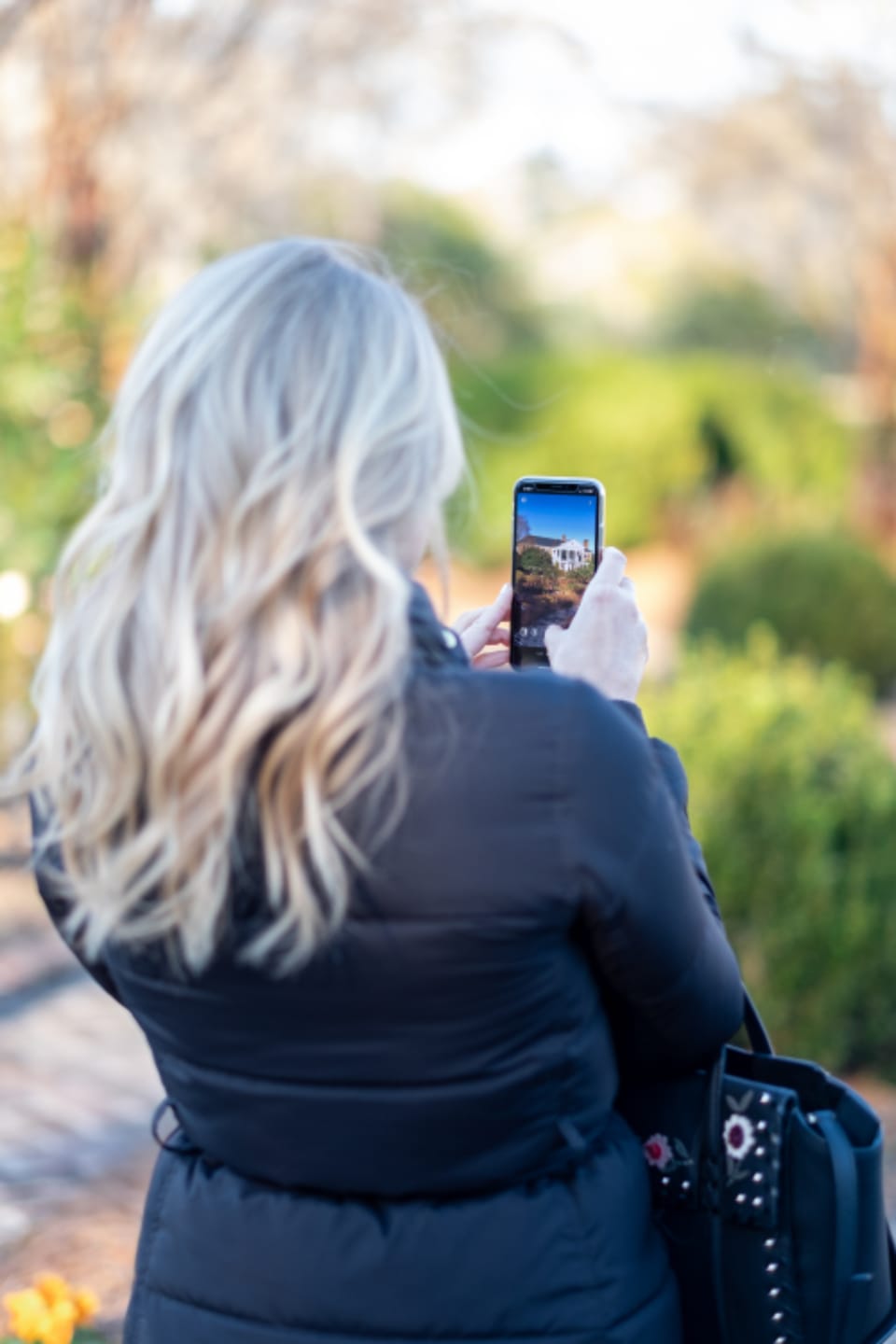 a person photographing a scene on a smartphone to create social content that can later earn backlinks and brand mentions